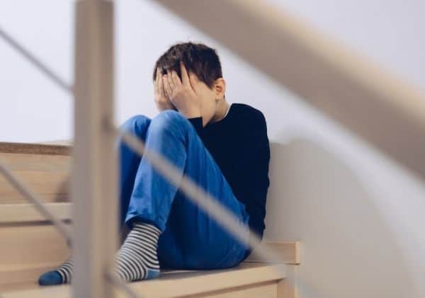 Enfant qui pleure dans les escaliers - Le deuil durant l'enfance - Blogue | Clinique de Psychologie Québec